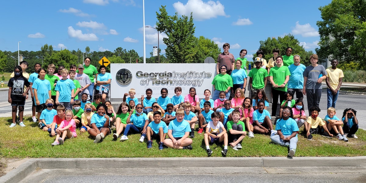 Students stand in fron of Georgia Tech Savannah Campus sign.