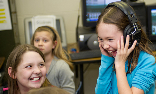 Excited student with headphones on